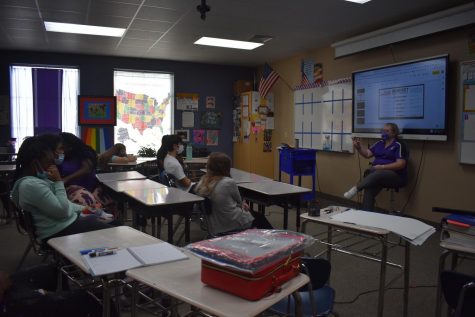 Kimberly Evans discusses with her homeroom class the topic of the day.