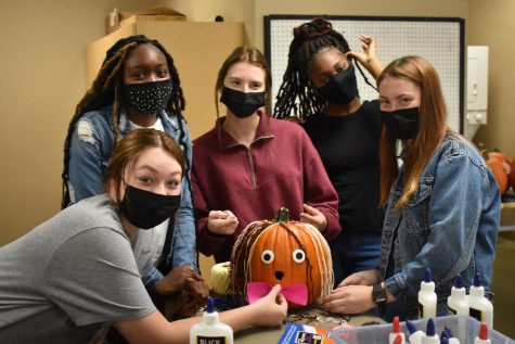 EHS students decorating their pumpkin with crafting materials.