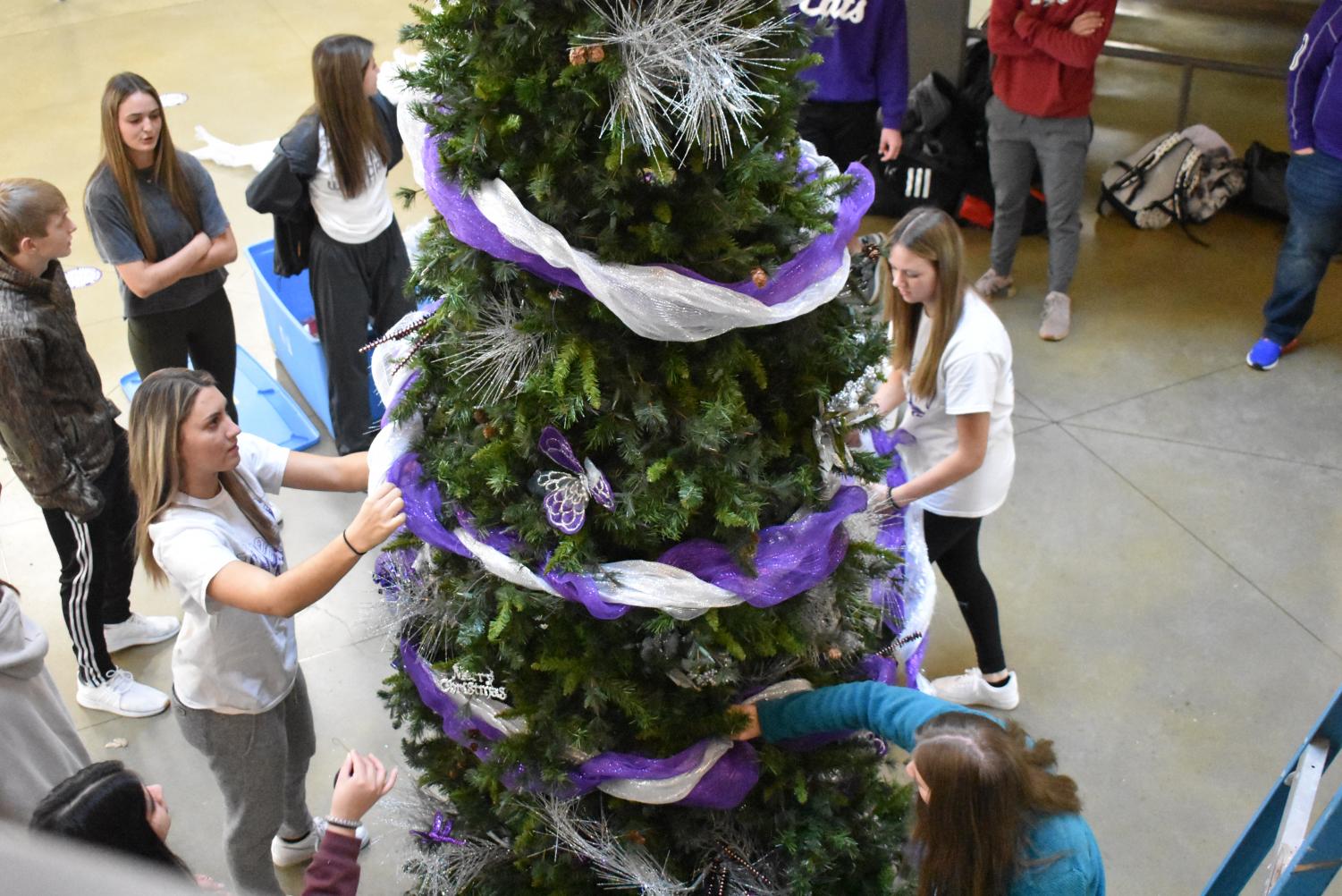 Student Council Decorates The School Christmas Tree