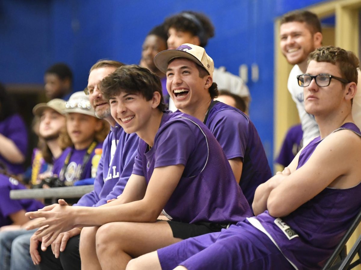 El Dorado Wildcat baseball players Sam York and Peyton Howard along with Coach Jeffery Burson and Skylar Vincent, celebrate a shot scored by their teammate during the Special Olympics basketball tournament.